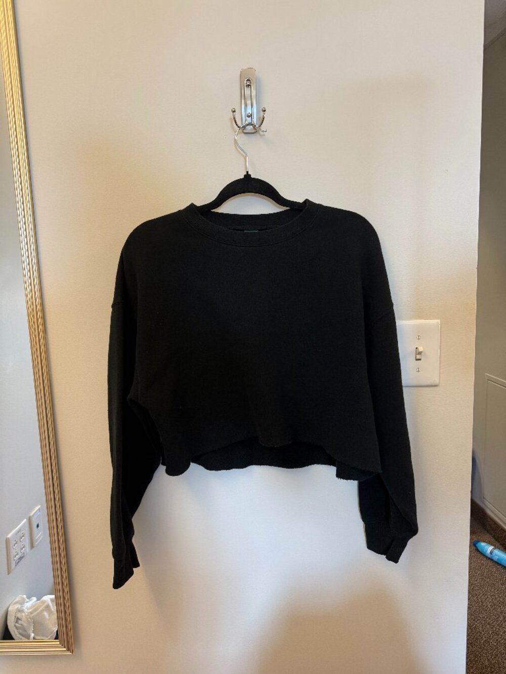 black crewneck. Cropped bottom